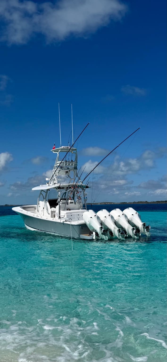 Southern Hook offshore Regulator running quad engines on clear blue water